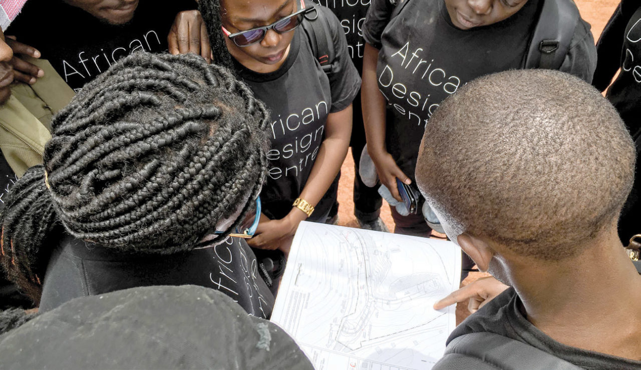 Jean Paul Uzabakiriho, design director at MASS Design Group, shows African Design Centre fellows around the Butaro campus and an ongoing project and construction site.