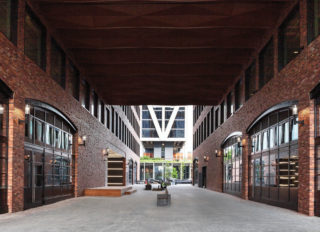 At ground level, 25 Kent’s two volumes are separated to create a pedestrian street between spaces for retail. At the third floor and above, a connector joins the north and south volumes, linking space for office tenants. Photo: Caroline LeFevre, courtesy of Gensler.