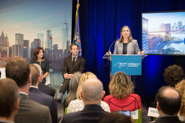 NYSERDA President and CEO Alicia Barton (speaking) alongside (left to right) Lt. Governor Kathy Hochul and Richard Yancy of Building Energy Exchange at the Buildings of Excellence Award Ceremony at the Building Energy Exchange in the Surrogate's Courthouse. Photo: Dan Creighton/DanCreighton.com.