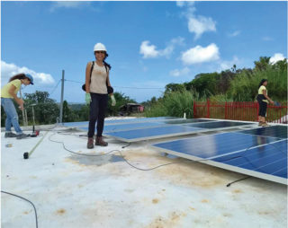 Members of the Solar Libre Puerto Rico team installing solar technology at a community center in the mountain town of Lares. Photo: courtesy of Walter Meyer.