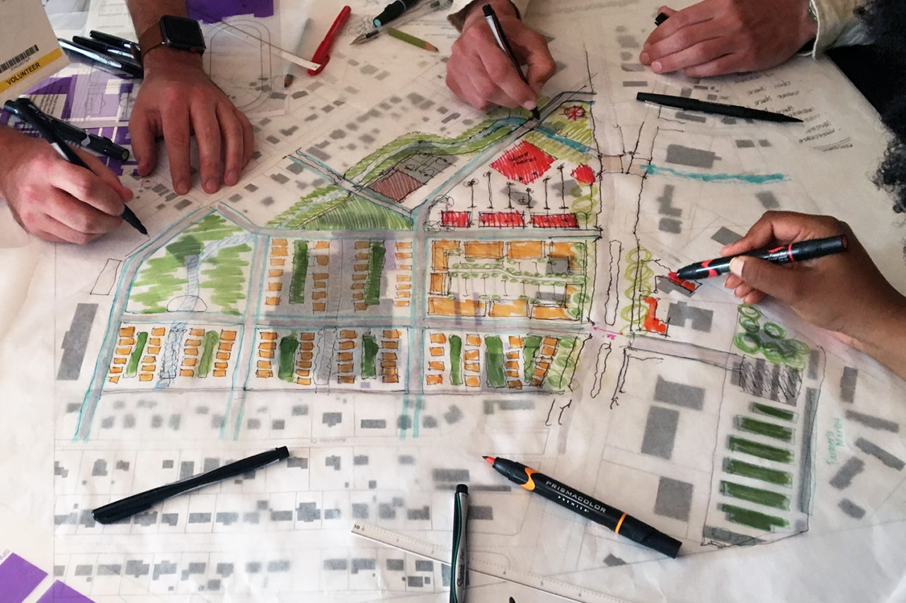 Participants sketching ideas for a proposed retrofit of a strip mall in suburban Jeffersonville, Indiana, during a professional planning and urban design workshop June Williamson conducted at a conference in Louisville in 2019. Photo: June Williamson.