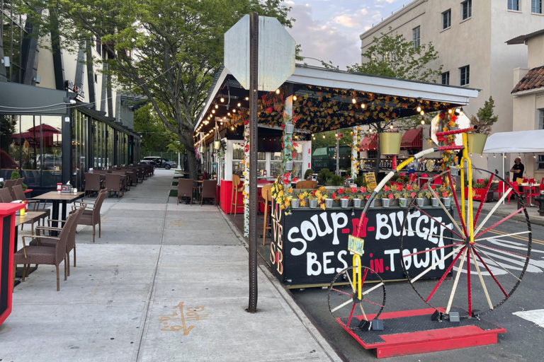 A photo of an outdoor dining shack on the street in New York City.