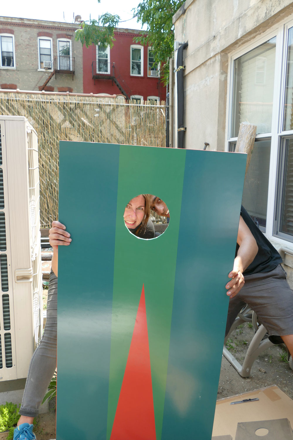 A photograph of 2 volunteers from Dattner Architects posing in the Services for the Underserved (S:US) urban garden spaces during AIANY Day of Service.