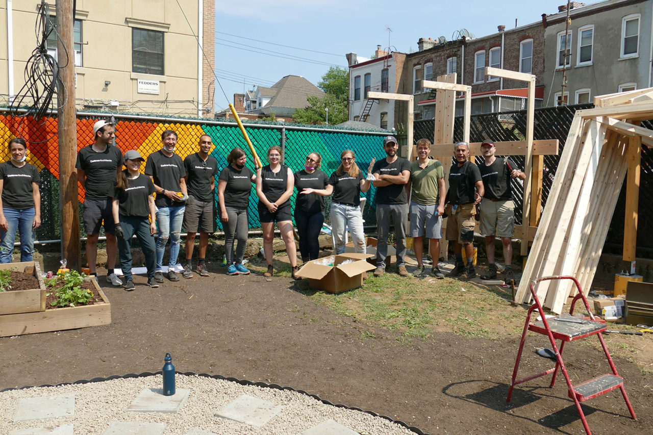 A photograph of volunteers from Dattner Architects posing in the Services for the Underserved (S:US) urban garden during AIANY Day of Service.