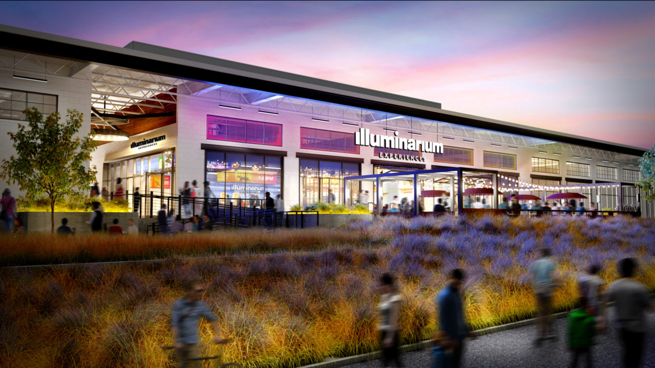A rendering of the exterior of the Atlanta Illuminarium, depicting a low-rise structure with purple lighting.