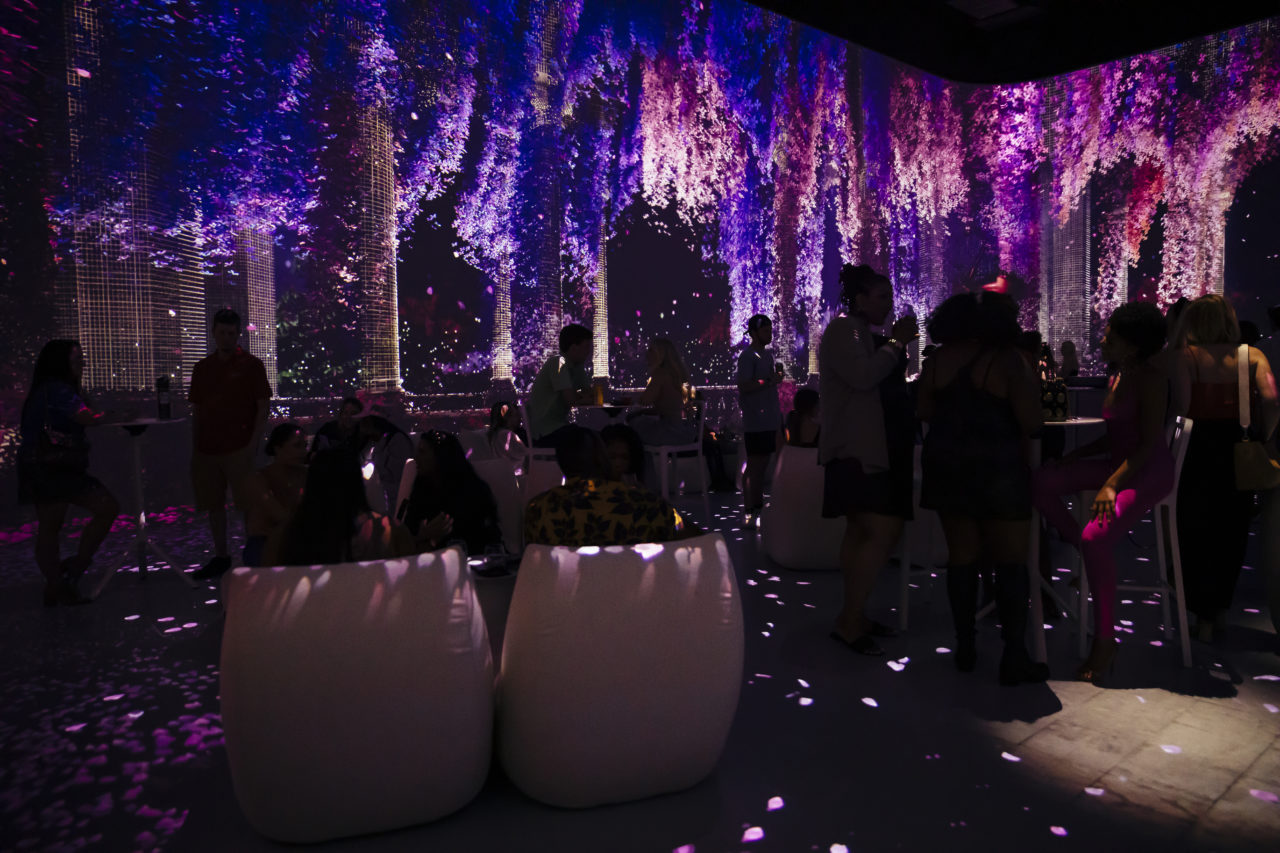 A photograph of one of the interiors at the Atlanta Illuminatium, activated with blue and purple lighting.