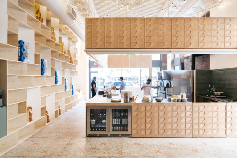 Photo of SIMÒ's open kitchen and lava stone shelving.