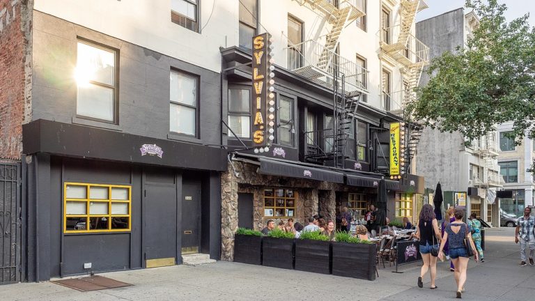 Photo of the outdoor dining area in front of Sylvia's, a restaurant located in Harlem.