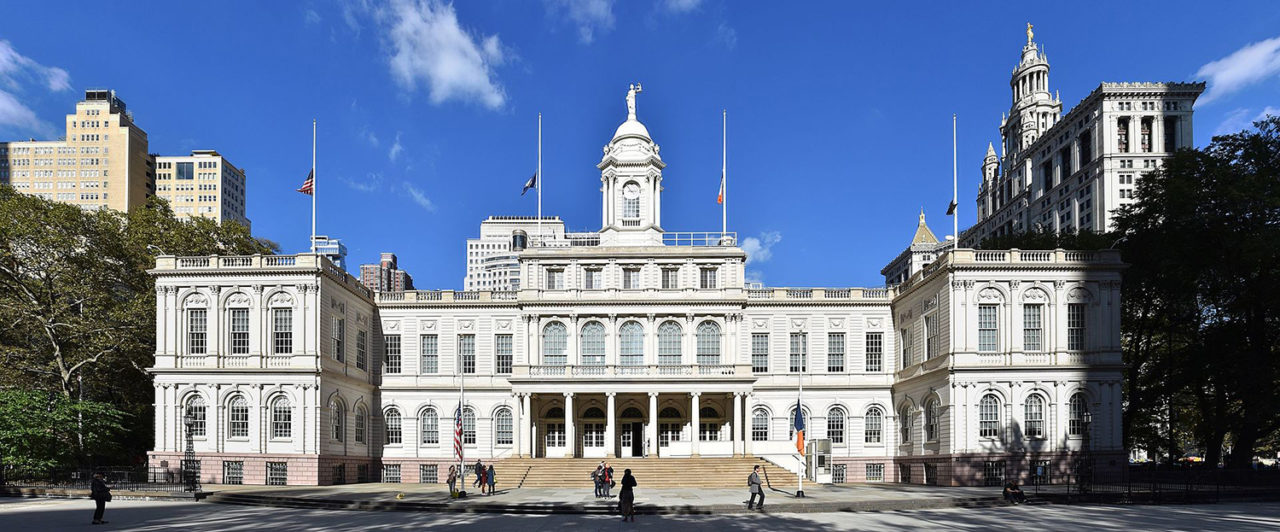 Photo of the front facade of New York City Hall.