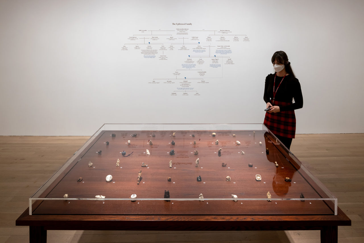 Photo of a table display of netsuke, featured in the exhibition Hare with Amber Eyes.