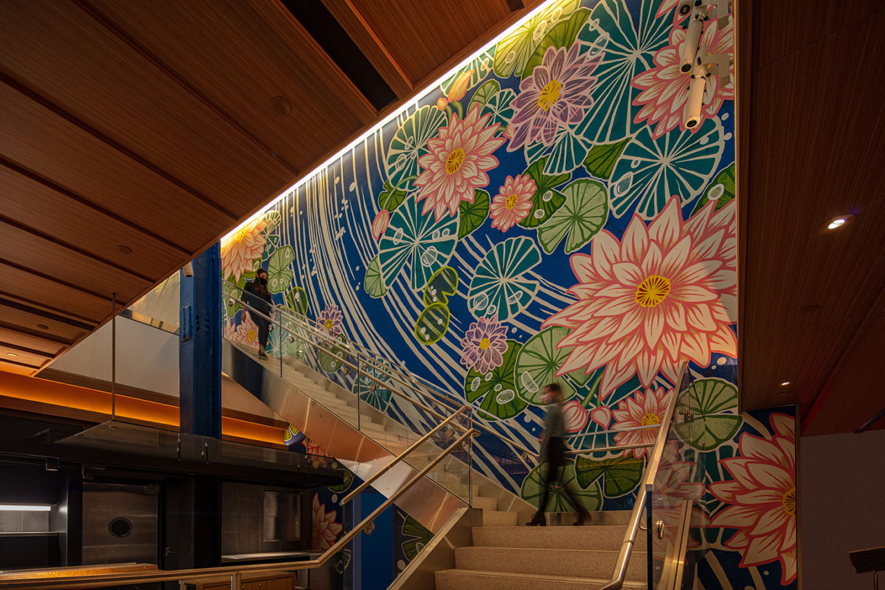 Photo of The Hugh, featuring a waterlily mural by artist Yuko Shimizu along a stair.