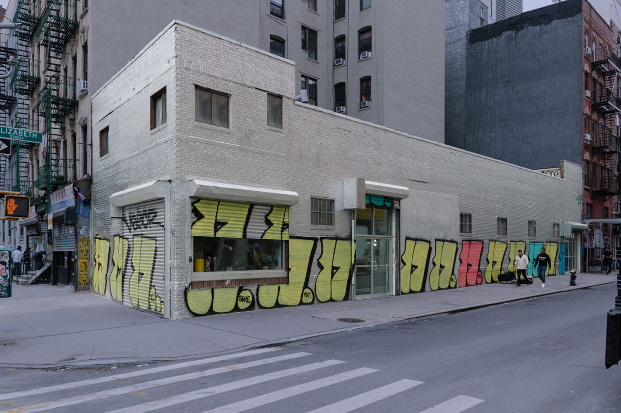 Photo of the exterior of Company Gallery, featuring a white facade and custom graffiti.