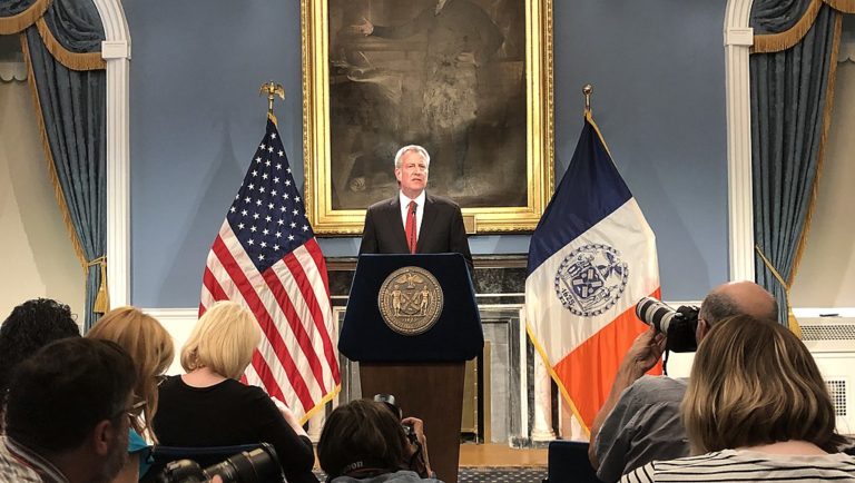 Photo of Mayor Bill de Blasio at the podium in the Blue Room in New York City Hall.