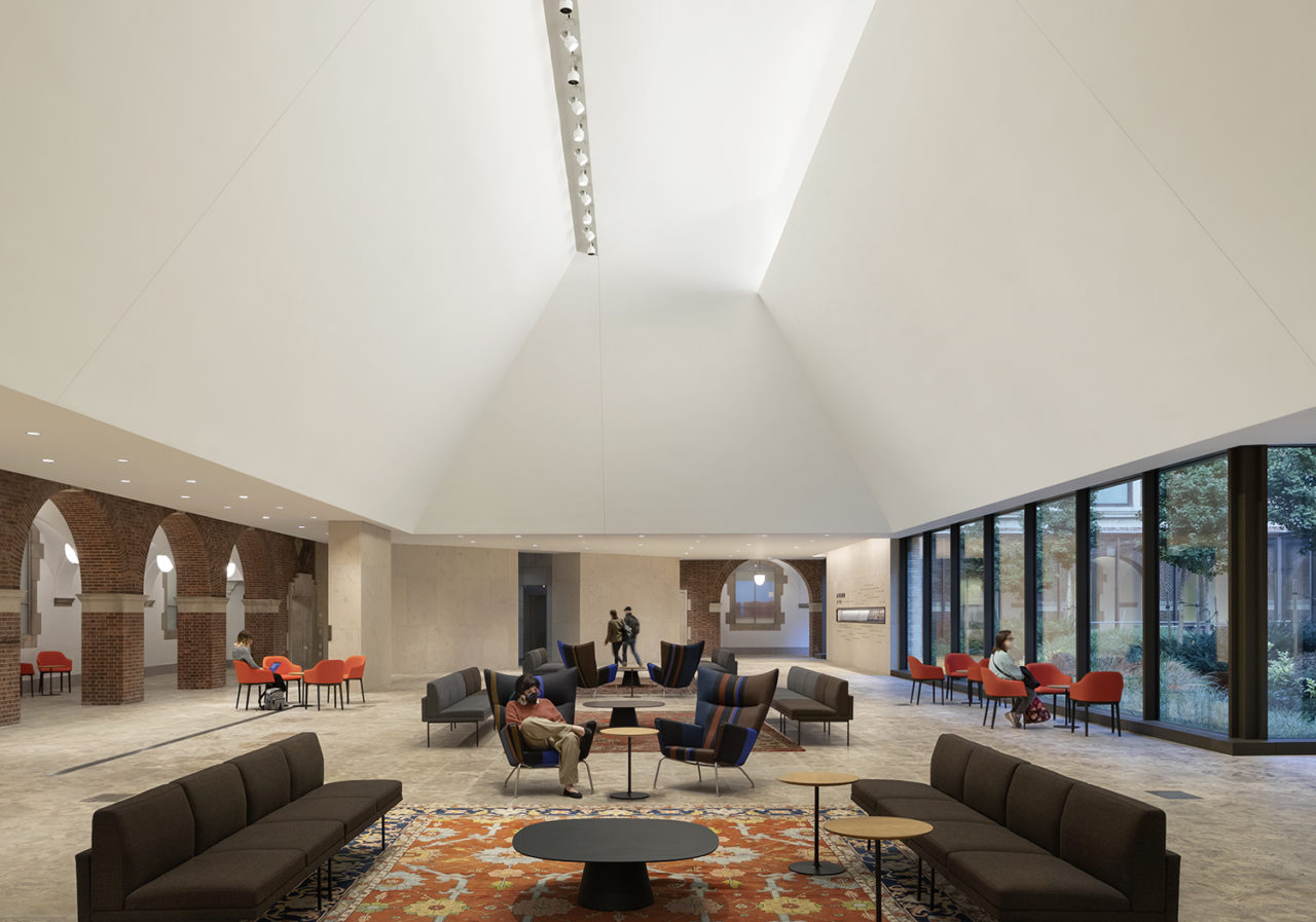 Photograph of the interior atrium of JTS expansion, featuring tall white ceilings and seating areas.