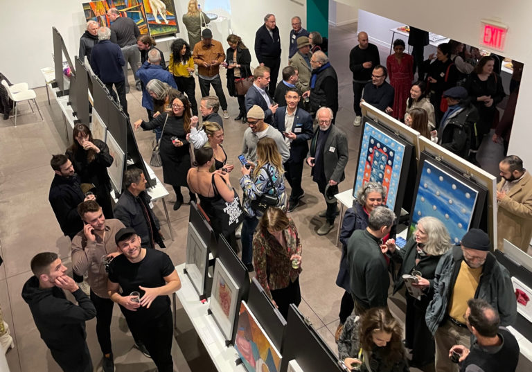 Large crowd at an exhibition opening.