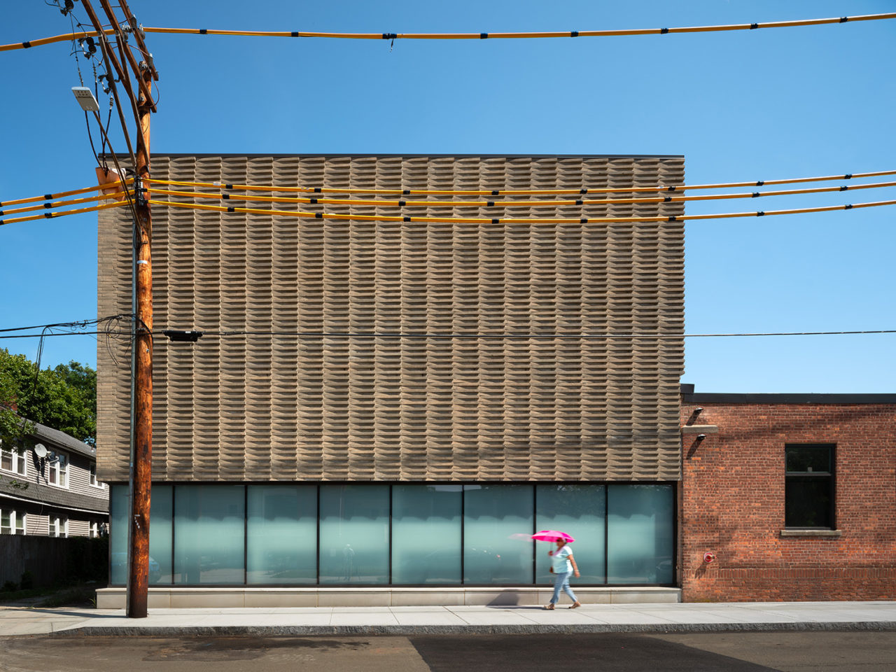 Exterior view of NXTHVN showing person walking on the street for scale.