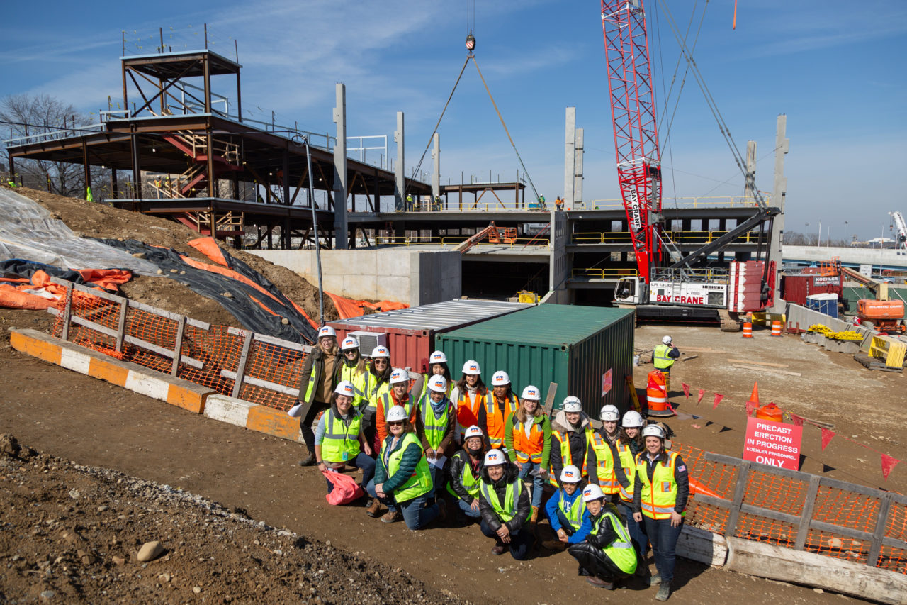 Construction site at Queens Garage and Community Space with the women in the team in the foreground.