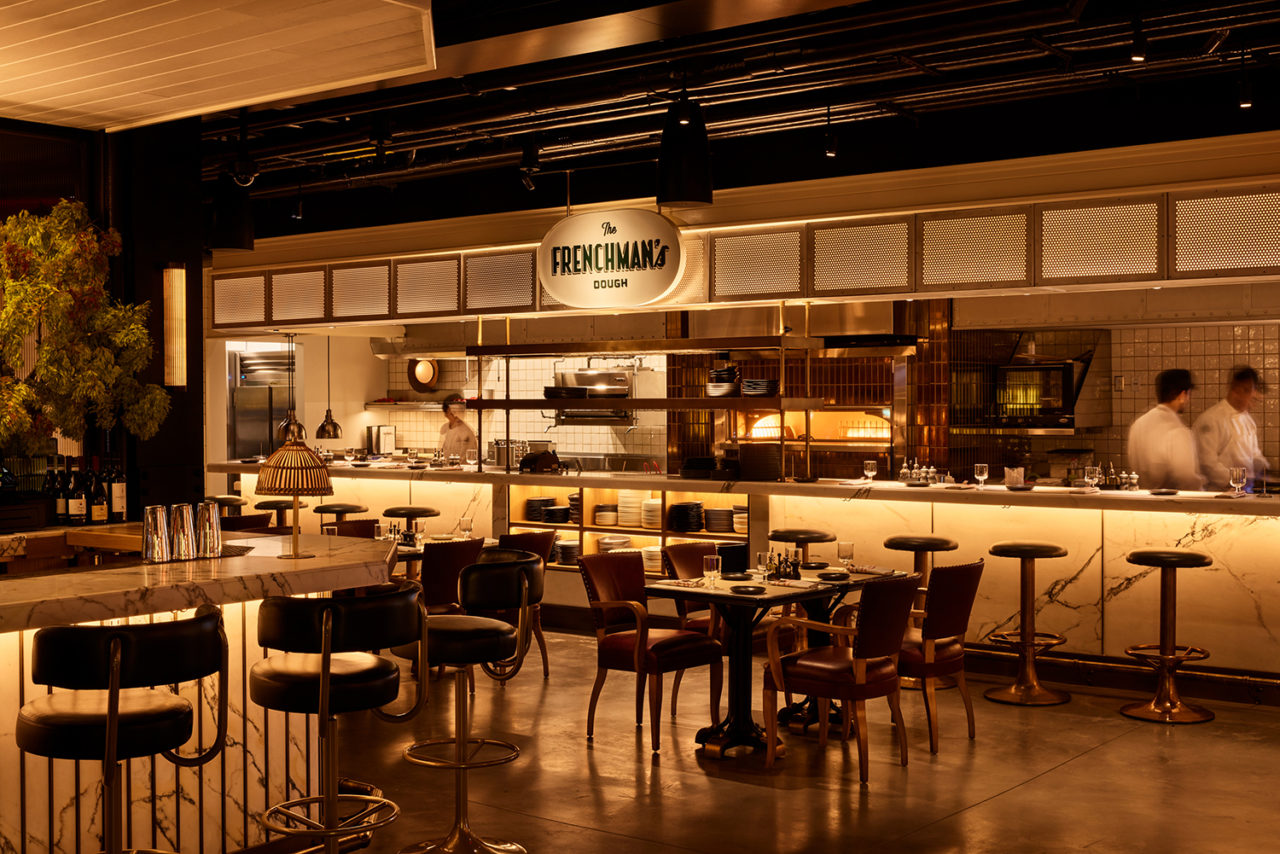 Restaurant interior featuring white tiles and a sign that reads "The Frenchman's"