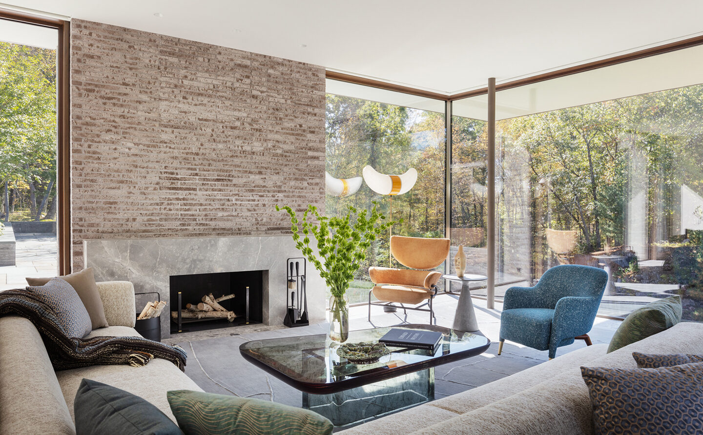 A living area interior with a striking coffee table, luxury furnishings, and a fireplace