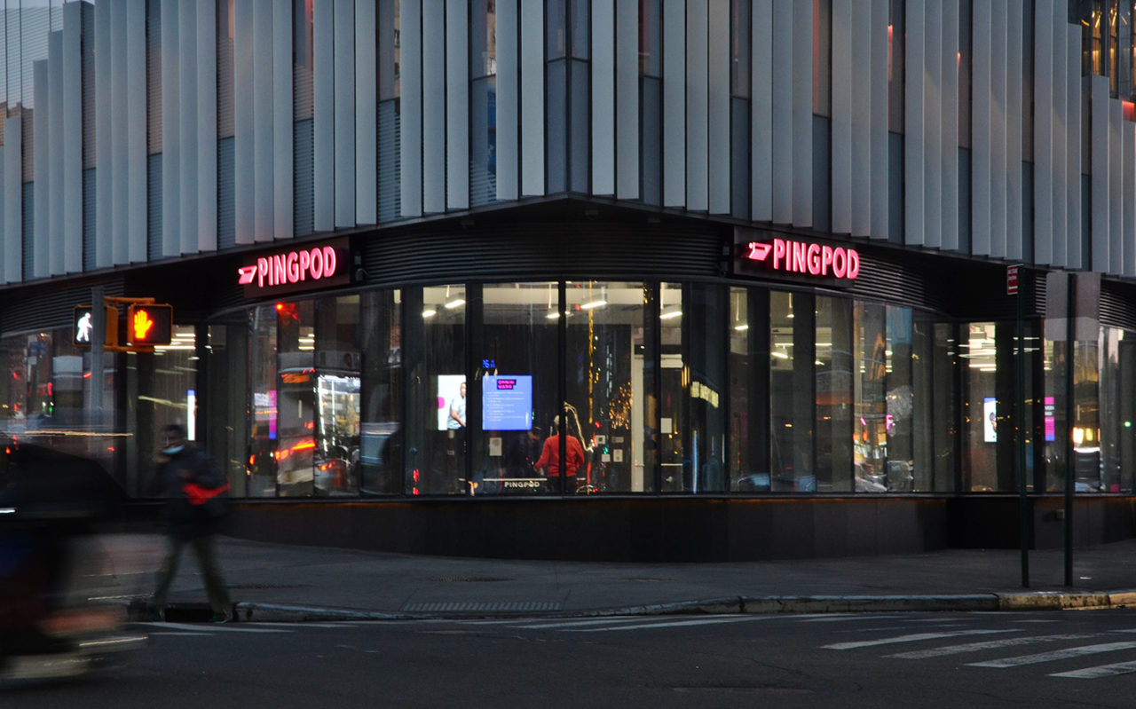 Exterior view of PingPod with pink signage and floor-to-ceiling windows