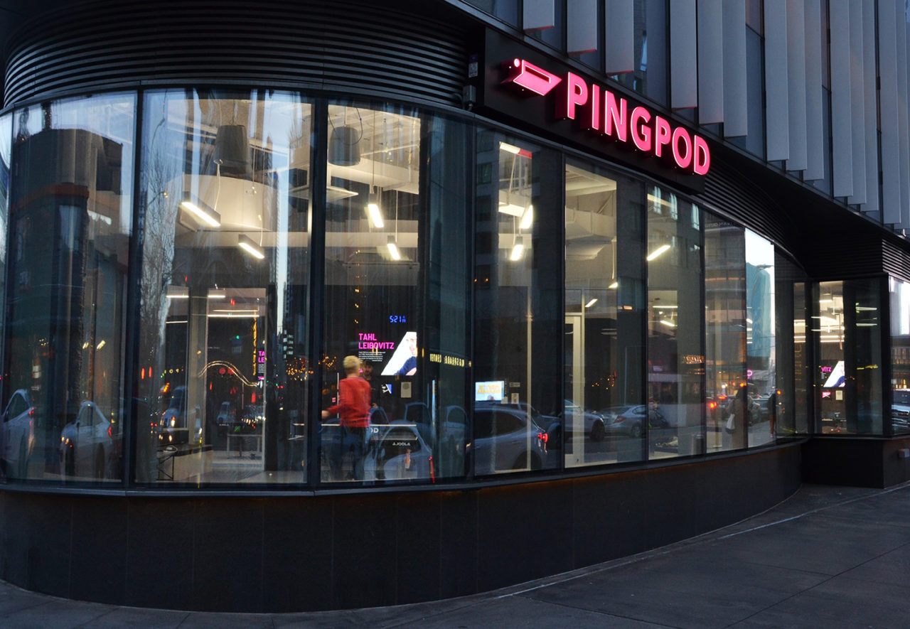 Exterior view of PingPod with pink signage and floor-to-ceiling windows