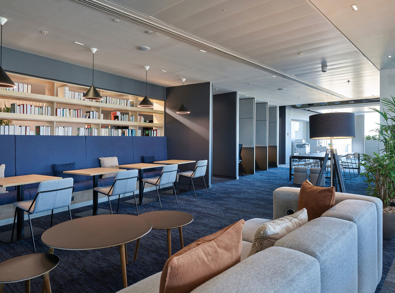 Interior of an office space with formal and informal seating and acoustic booths