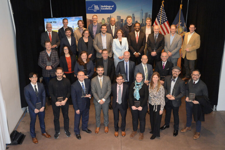 A posed photo of a large group of winners and event participants at the Center for Architecture