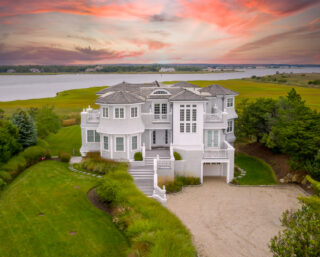 Exterior of a grand house in the countryside at sunset