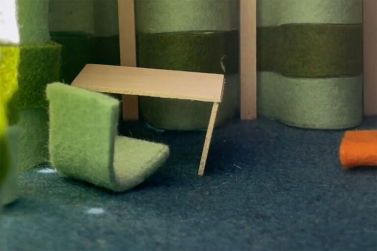 Recipe for a Room 2023 winning project, a miniature room in green felt with a min chair and desk inside it