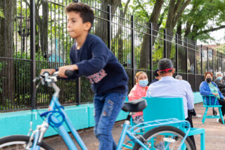 A boy rides his bicycle at the Refreshing Water site in the Bronx, NY.