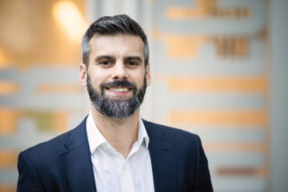 Headshot of Jesse Lazar standing outside the Center for Architecture front doors