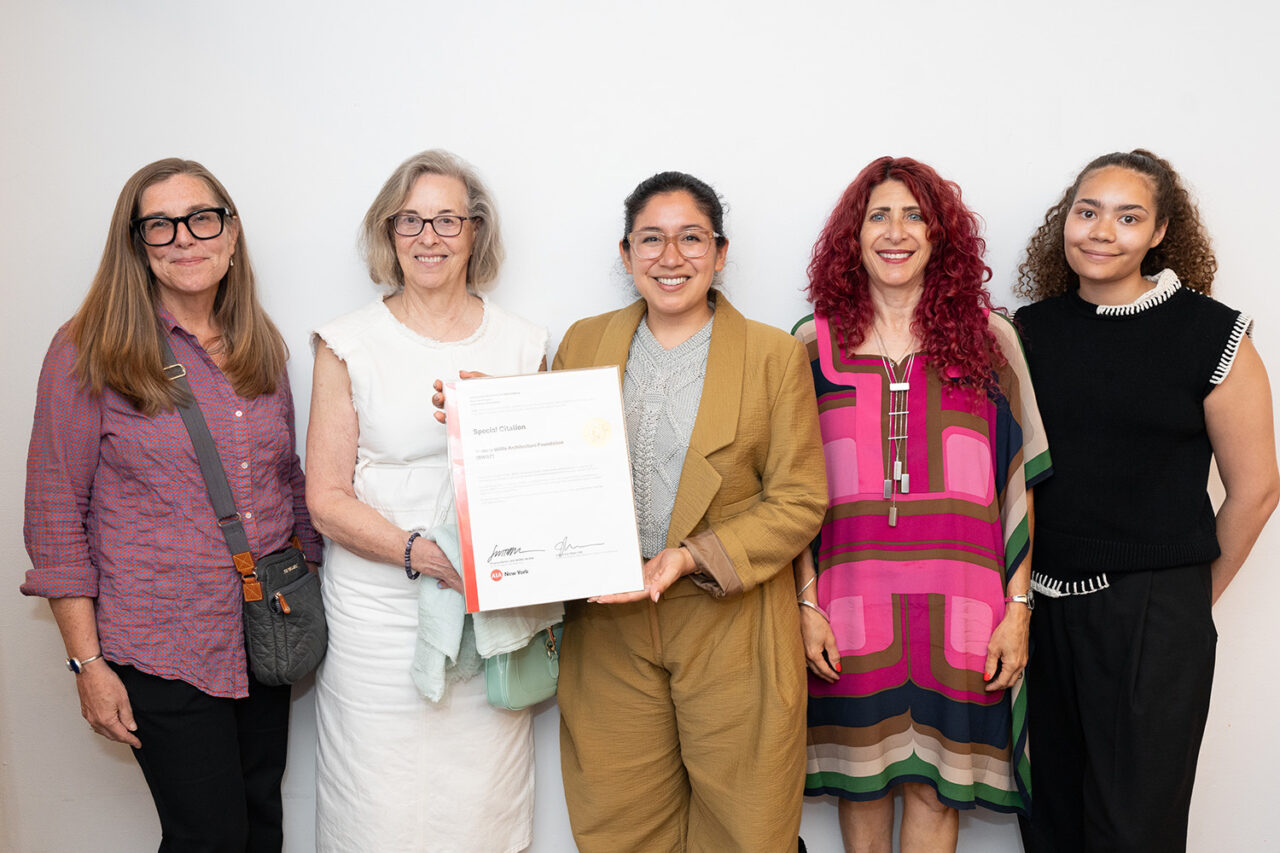 Five women representing the Beverly Willis Foundation stand with their certificate
