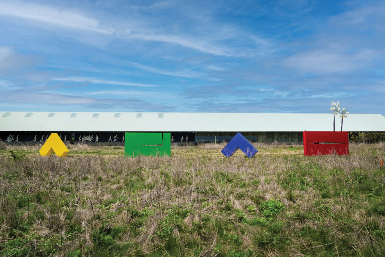Carmen Herrera's four acrylic structures stand in the Parrish Museum's field of grass.