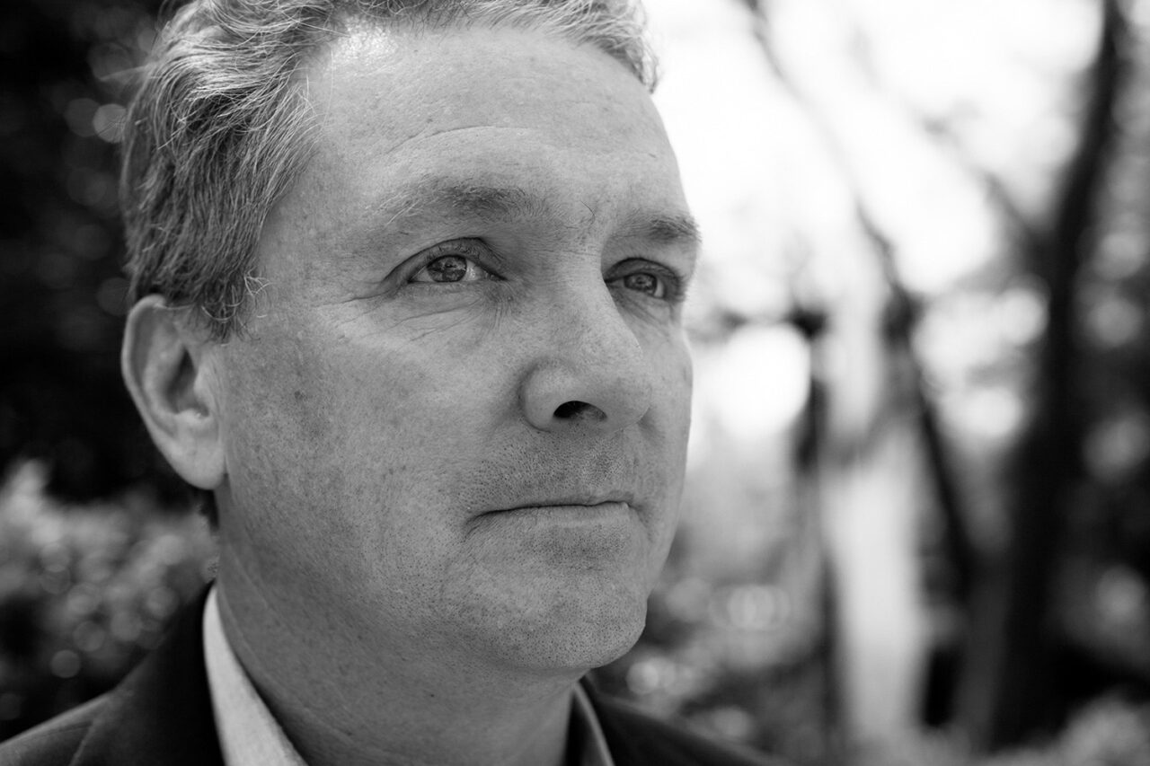 Headshot of Michael J. Monti, a black and white portrait of a white man with dark eyes.