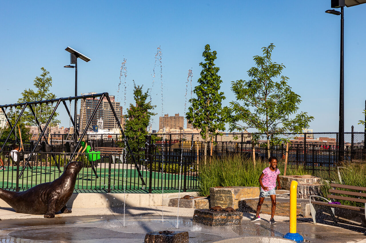 Kids play by the water and in the playground of Pier 42.