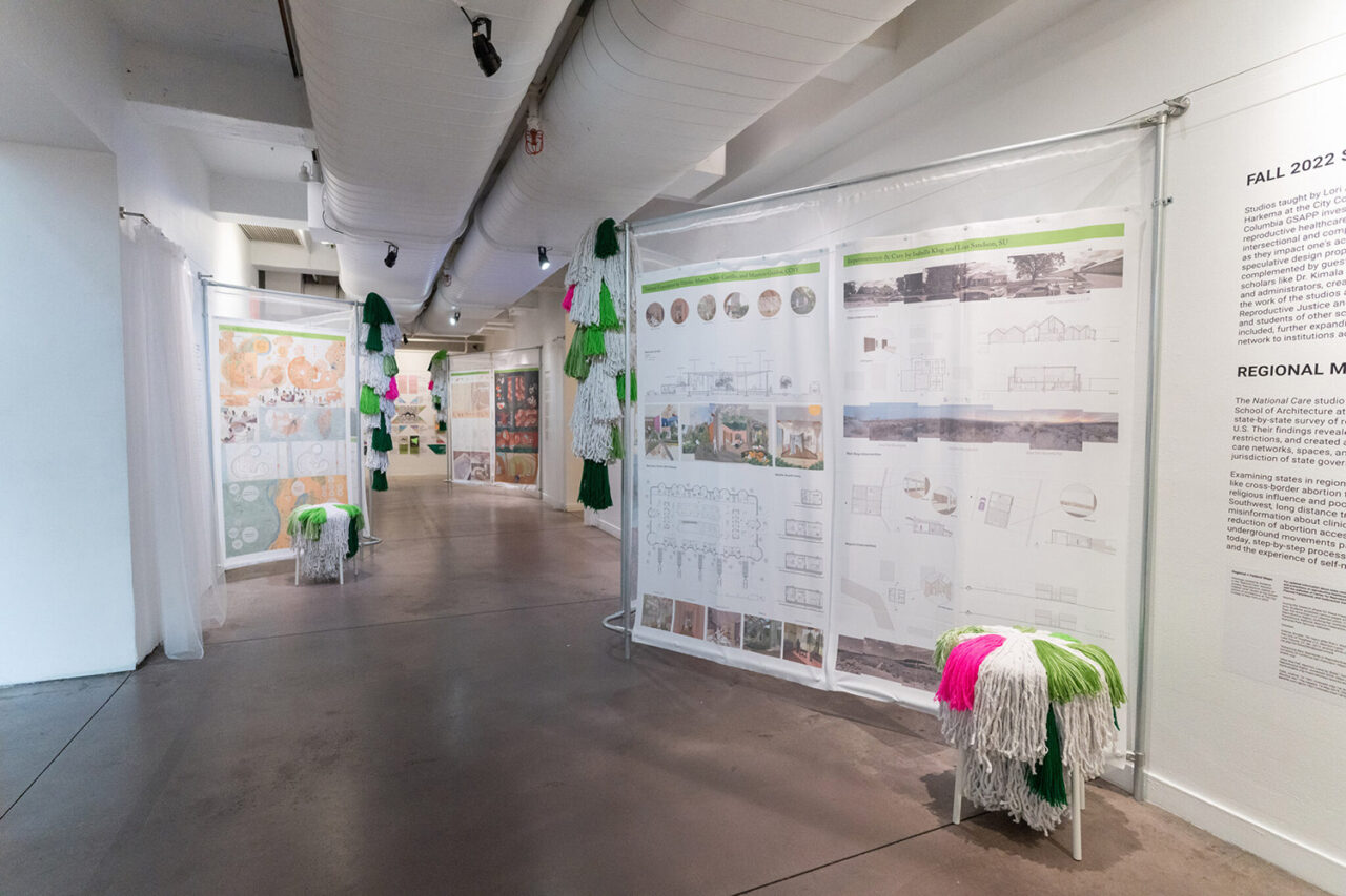 A view of the exhibition, featuring, at left, "Away, at Home" by Chi Chi Wakabayashi, a student at Columbia University's Graduate School of Architecture, Planning and Preservation. The project proposes a clinic offering temporary housing and social support services to provide comfort for those who have to travel to access care. From the studio Reproductive Justice Network, taught by Bryony Roberts, 2022.