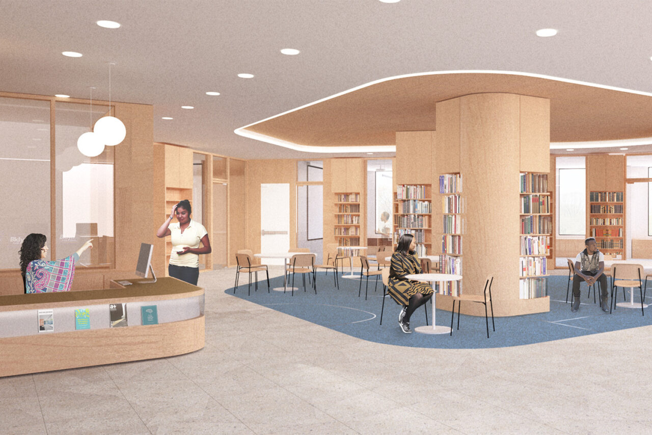 Lobby space of Brooklyn Public Library. A front desk on the left and standard library scene in the background.
