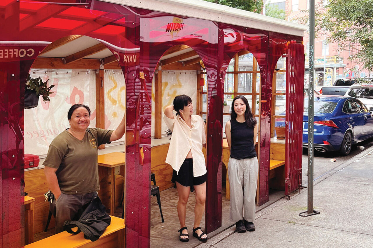 Red dining shed for Maya Congee Cafe. The owner, contractor, and architect stand in front of the structure on demolition day.