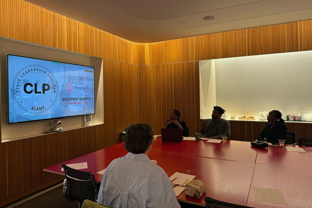 AIANY Civic Leadership Program development session in progress, with several people seated at along a table engaged in discussion and listening