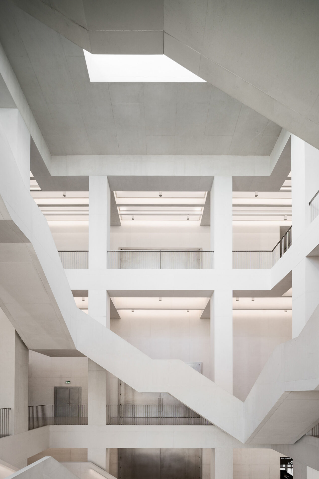 Interior shot of the floors and columns in the museum. All white with a skylight above.