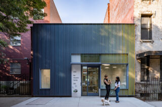 Exterior of Pet Adoption Center with gray-yellow ombre paneling.