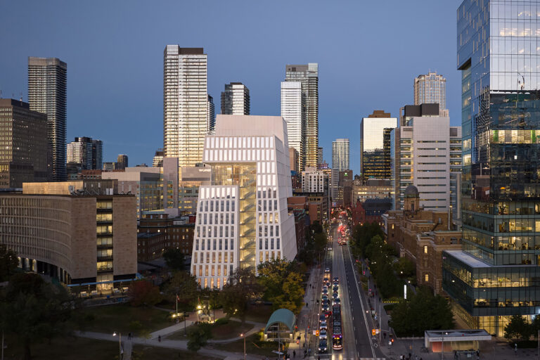 Faraway exterior shot in evening view of University of Toronto Schwartz Reisman Innovation Campus building.