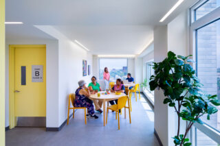 People sitting around a few tables in a meeting area of Casa Celina.