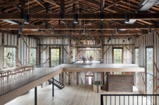 The Church interior, showcasing two stories of wood paneling and airy space