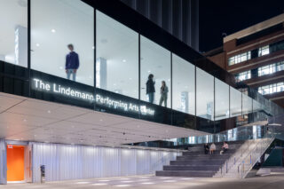 Exterior shot of Lindemann Performing Arts Center. Stairway up to hallway with floor-to-ceiling windows.
