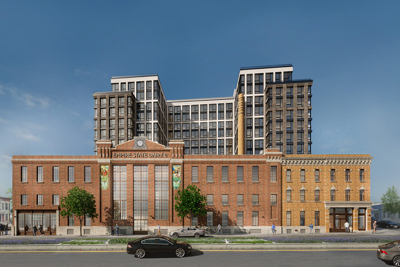 Exterior rendering the whole redeveloped Empire State Dairy complex, a wide red building structure.