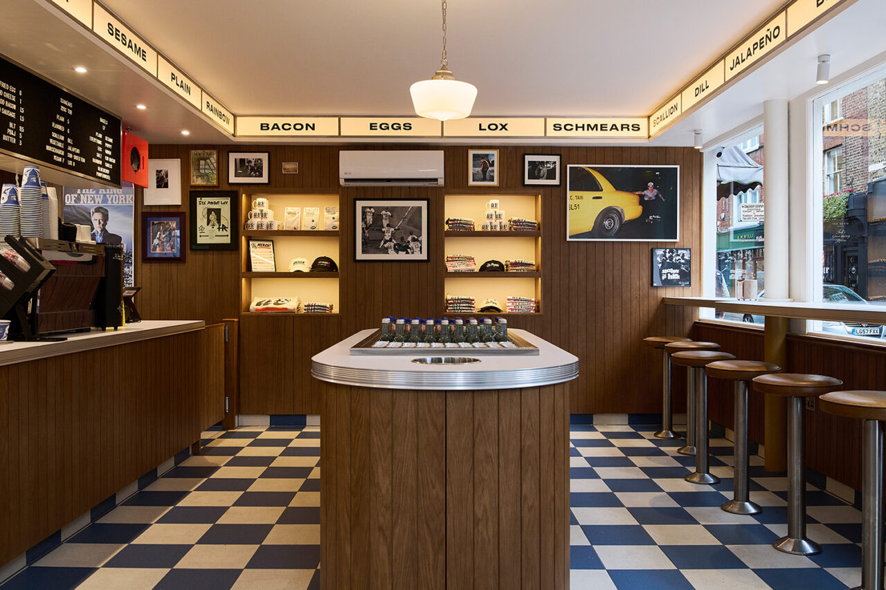Interior scene of bagel shop with checkerboard flooring.