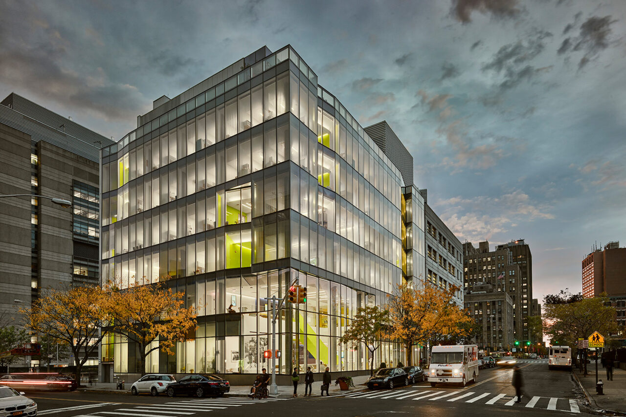 Exterior shot of a glowing school building in evening light.