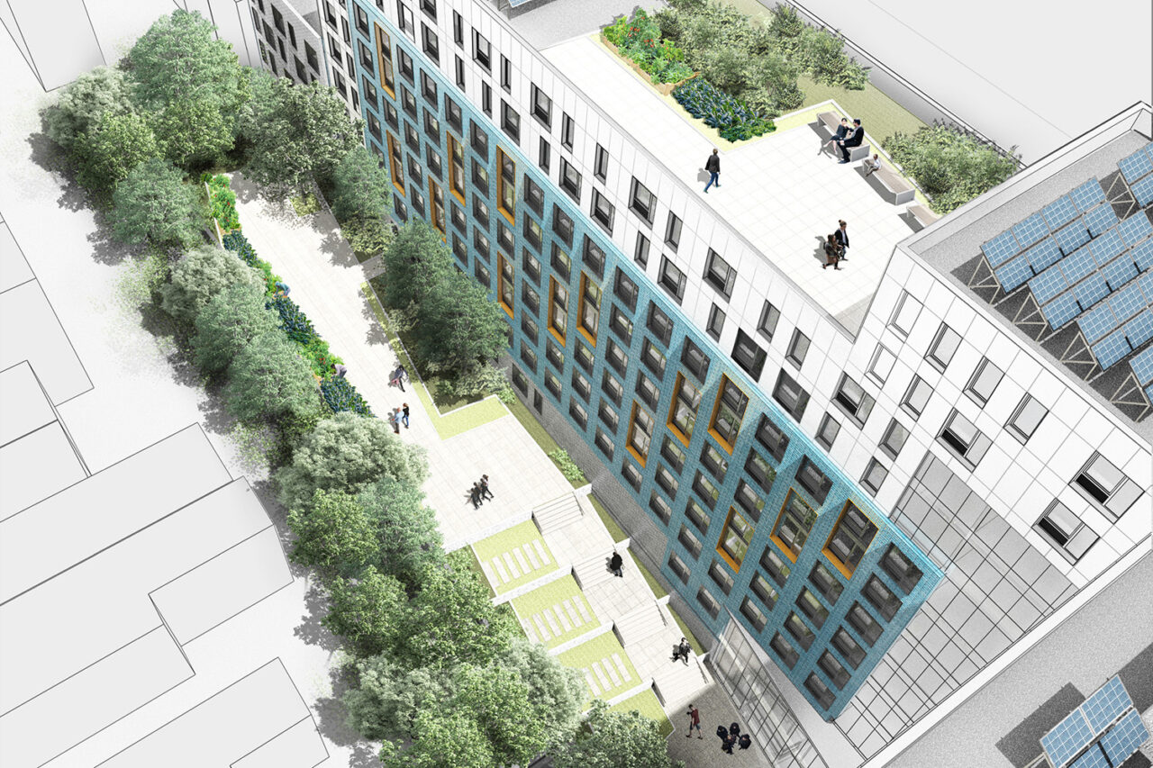 Aerial view of blue and white residential building with green courtyard.
