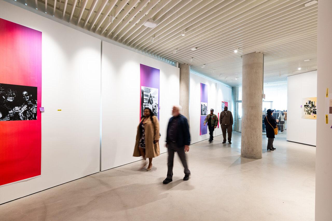 Interior art gallery space with people milling about